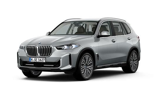 BMW X5 Angebot Ein hellgrauer oder silberner BMW X5 SUV ist als Studioaufnahme vor einem weißen Hintergrund zu sehen. Das Fahrzeug ist in einer leicht schrägen Vorderansicht dargestellt, mit eingeschalteten Scheinwerfern. Die Felgen haben ein komplexes Speichendesign. Das Kennzeichen lautet "M SE 1627".